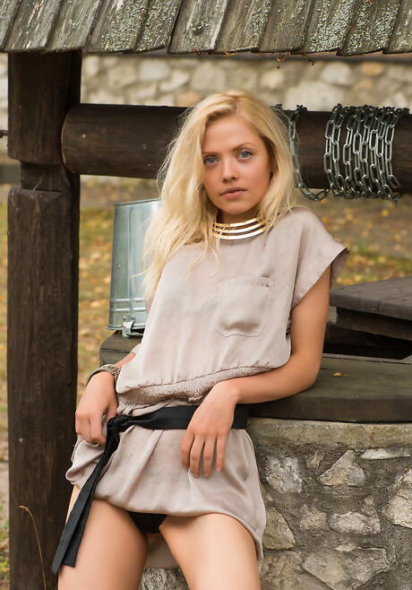 Rangy blond youthful Camelia showing small tits and shaved pussy outdoor